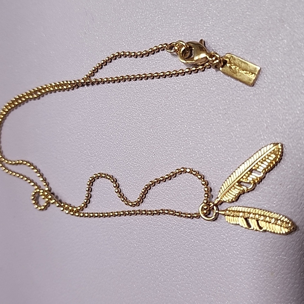 EUC Coach Gold-plated Feather Pendant Necklace With Crystal Accent